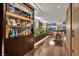 Wide angle shot of a living area and bar, featuring indoor plants and natural light at 353 E Bonneville Ave # 1302, Las Vegas, NV 89101