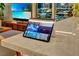 Modern living room featuring a smart tablet on a marble surface and an ocean view on the television at 353 E Bonneville Ave # 1302, Las Vegas, NV 89101