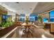Open-concept living space with floor-to-ceiling windows, hardwood floors, custom planter, and a modern dining area at 353 E Bonneville Ave # 1302, Las Vegas, NV 89101