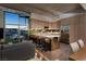 Open concept living and kitchen area with sleek island and modern wood cabinetry, great for entertaining at 353 E Bonneville Ave # 1302, Las Vegas, NV 89101