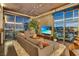 Comfortable living room with a large sectional sofa, city views, and modern interior design at 353 E Bonneville Ave # 1302, Las Vegas, NV 89101