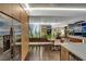 Open-concept living space adjacent to the kitchen with a dining area, featuring sleek, modern design and indoor plants at 353 E Bonneville Ave # 1302, Las Vegas, NV 89101