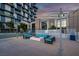Contemporary outdoor lounge area with modern seating and a built-in fire pit feature at 353 E Bonneville Ave # 1302, Las Vegas, NV 89101