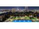 Night view of a luxury condominium rooftop pool and lounge area, with the city skyline in the background at 353 E Bonneville Ave # 1302, Las Vegas, NV 89101