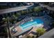 Aerial view of a community pool with lounge chairs, cabanas, and lush palm trees creating a resort-like atmosphere at 353 E Bonneville Ave # 1302, Las Vegas, NV 89101