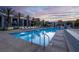 Exterior view of a luxurious pool area with palm trees and lounge chairs near condos at 353 E Bonneville Ave # 1302, Las Vegas, NV 89101