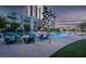Apartment complex with outdoor swimming pool, modern lounge furniture, and landscaped grounds at 353 E Bonneville Ave # 1302, Las Vegas, NV 89101