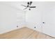 Bedroom with ceiling fan, light wood floors, and a window, offering a bright, airy feel at 3654 Villa Knolls South Dr, Las Vegas, NV 89120
