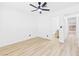 Bright bedroom featuring ceiling fan, light wood floors, and access to an ensuite bathroom at 3654 Villa Knolls South Dr, Las Vegas, NV 89120