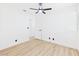 Bright bedroom with ceiling fan, light wood floors, and white walls creating a modern aesthetic at 3654 Villa Knolls South Dr, Las Vegas, NV 89120