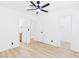 Bedroom with a ceiling fan, light wood floors, and white walls for a bright, modern look at 3654 Villa Knolls South Dr, Las Vegas, NV 89120