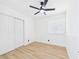 Bright bedroom featuring closet, wood floors, ceiling fan, and a window with blinds at 3654 Villa Knolls South Dr, Las Vegas, NV 89120