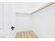 Walk-in closet with ample storage space and minimalist design, featuring wood flooring at 3654 Villa Knolls South Dr, Las Vegas, NV 89120