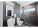 Modern bathroom featuring a vessel sink, a wall-mounted toilet, a glass-enclosed shower, and sleek, dark textures at 3740 Caesars Cir, Las Vegas, NV 89120
