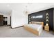 Modern bedroom with walk-in closet features a striking black accent wall and sleek, contemporary furnishings at 3740 Caesars Cir, Las Vegas, NV 89120