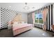 Charming bedroom with black and white striped and polka dot walls, pink accents, and a contemporary lighting fixture at 3740 Caesars Cir, Las Vegas, NV 89120
