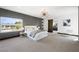 Expansive primary bedroom featuring a gray accent wall, modern lighting fixture, and a door leading to the bathroom at 3740 Caesars Cir, Las Vegas, NV 89120