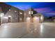 Expansive driveway leads to a modern home with multi-car garage and clean architectural lines at 3740 Caesars Cir, Las Vegas, NV 89120