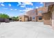Exterior elevation of the front of the property featuring a large driveway, modern architecture, and manicured landscaping at 3740 Caesars Cir, Las Vegas, NV 89120