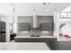 Elegant kitchen with gray cabinetry, marble backsplash, and modern pendant lights at 3740 Caesars Cir, Las Vegas, NV 89120
