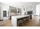 Bright, modern kitchen features an island with seating and a stylish lighting fixture at 3740 Caesars Cir, Las Vegas, NV 89120