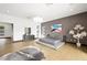 A modern main bedroom features hardwood floors, stylish decor, and lots of natural light from a large window at 3740 Caesars Cir, Las Vegas, NV 89120