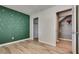 Bedroom with accent wall, wood-look flooring, and closet and laundry access at 3811 Twinkle Star Dr, Las Vegas, NV 89115