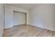 Bright bedroom featuring wood-look floors and an open closet at 3811 Twinkle Star Dr, Las Vegas, NV 89115