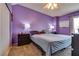 Bedroom featuring purple walls, plush carpet, and ceiling fan at 3811 Twinkle Star Dr, Las Vegas, NV 89115