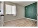 Bedroom featuring wood-look floors and a moon and stars accent wall at 3811 Twinkle Star Dr, Las Vegas, NV 89115