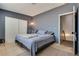 Bedroom with gray walls, plush carpet, a bed, and access to another room at 3811 Twinkle Star Dr, Las Vegas, NV 89115