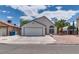 The inviting home boasts a well-maintained front yard with a spacious driveway and garage at 3811 Twinkle Star Dr, Las Vegas, NV 89115