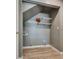 Under-stairs laundry area with shelving, wood-look floors, and gray walls at 3811 Twinkle Star Dr, Las Vegas, NV 89115