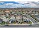 Neighborhood aerial view showcasing modern homes and desert landscaping, near the mountains at 4177 Railhead Pass Ave, Las Vegas, NV 89141