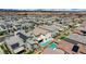Aerial view showcasing a modern community with homes, some equipped with solar panels and backyard pools at 4177 Railhead Pass Ave, Las Vegas, NV 89141