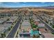 Neighborhood aerial view showcasing modern homes, desert landscaping, and distant hotels at 4177 Railhead Pass Ave, Las Vegas, NV 89141