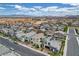 Neighborhood aerial view showcasing modern homes and desert landscaping, near the mountains at 4177 Railhead Pass Ave, Las Vegas, NV 89141