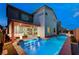 A lovely backyard with a sparkling pool, relaxing lounge chairs, and cozy fire features for outdoor enjoyment at 4177 Railhead Pass Ave, Las Vegas, NV 89141