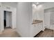 Neutral bathroom with a double sink vanity, white cabinetry, and warm lighting, offering practicality at 4177 Railhead Pass Ave, Las Vegas, NV 89141