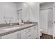 Elegant bathroom featuring double sinks, a large mirror and a pristine shower-tub combination at 4177 Railhead Pass Ave, Las Vegas, NV 89141