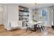 Contemporary dining room featuring a stylish bar area, sleek shelving and a modern light fixture at 4177 Railhead Pass Ave, Las Vegas, NV 89141