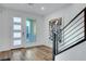 Entryway featuring modern door and staircase with art piece, enhancing the contemporary design at 4177 Railhead Pass Ave, Las Vegas, NV 89141