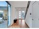 Bright entryway featuring wood floors, modern door, and view to brick patio with outdoor seating at 4177 Railhead Pass Ave, Las Vegas, NV 89141