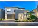 Contemporary two-story home showcasing sleek architecture and manicured landscaping at twilight at 4177 Railhead Pass Ave, Las Vegas, NV 89141