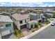 Eye-level shot of a modern two-story home with neutral colors and landscaped front yard at 4177 Railhead Pass Ave, Las Vegas, NV 89141