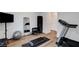 Well-equipped home gym with a treadmill, weights, and wood-look flooring, perfect for fitness enthusiasts at 4177 Railhead Pass Ave, Las Vegas, NV 89141