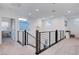 Second floor hallway with carpet floors and modern chandelier, enhancing the home's contemporary design at 4177 Railhead Pass Ave, Las Vegas, NV 89141