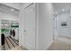 Hallway leads to a modern laundry room, featuring geometric tile floors and state-of-the-art appliances for easy chores at 4177 Railhead Pass Ave, Las Vegas, NV 89141