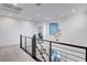 Second floor hallway featuring carpet floors and modern chandelier, creating a stylish and bright living space at 4177 Railhead Pass Ave, Las Vegas, NV 89141