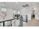 Hallway with modern chandelier and metal railings, creating an airy and bright atmosphere at 4177 Railhead Pass Ave, Las Vegas, NV 89141